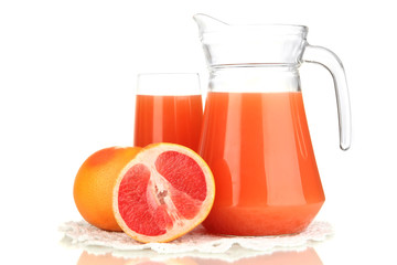Full glass and jug of grapefruit juice and grapefruits isolated