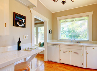 White kitchen with cherry hardwood floor.