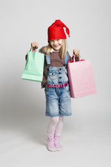 Happy young girl carrying Christmas shopping bags