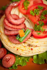 Grilled sausage with pasta, vegetables and spices