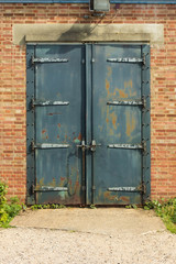 Old rusty padlocked blue metal door
