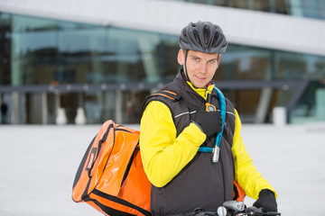 Cyclist With Courier Delivery Bag Using Walkie- Talkie
