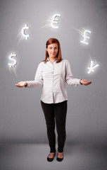 young lady standing and juggling with currency icons