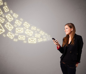 attractive young lady holding a phone with message icons
