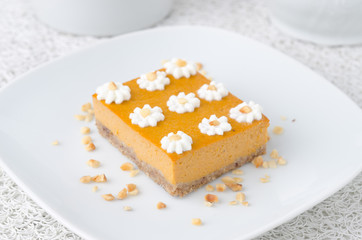 Pumpkin cake, decorated with flowers made of whipped cream
