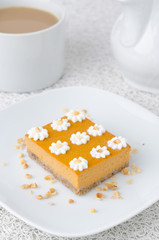Pumpkin cake, decorated with flowers made of whipped cream