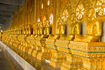 row of golden monk buddhist statues in thai temple, Chaimongkhol