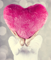 Girl show toy heart.