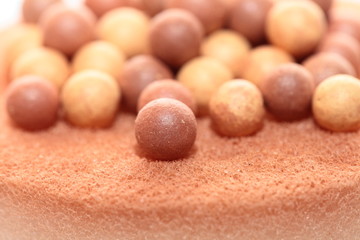 Beige cosmetics multicolor rouge balls background, macro view
