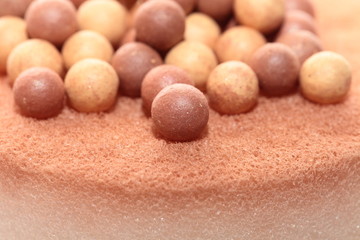 Beige cosmetics multicolor rouge balls background, macro view