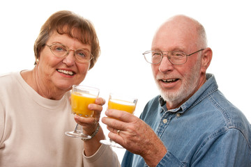 Happy Senior Couple with Glasses of Orange Juice