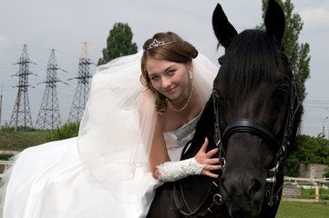 Obraz premium fiancee in a wedding dress astride on a horse