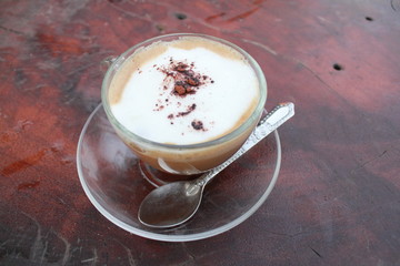 coffee cup against wooden background.