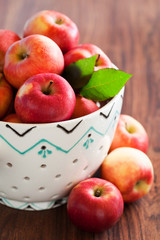 Fresh ripe apples in ceramic colander, selective focus