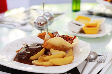 Grilled meat with baked potatoes