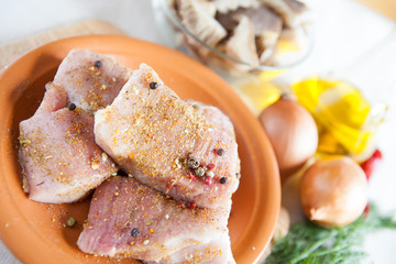 large chunks of raw meat with spices