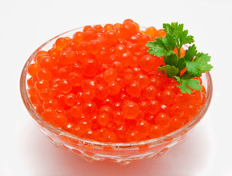 Red caviar in the bowl isolated