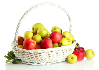 juicy apples with green leaves in basket, isolated on white