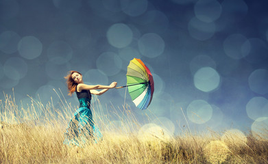 Redhead girl with umbrella at outdoor.