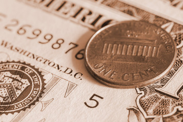 one cent coin on banknote close up