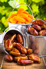 Delicious dried apricots and dates in tin pail