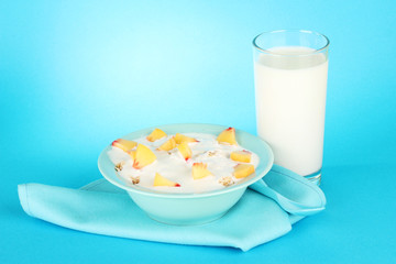 tasty dieting food and glass of milk, on blue background