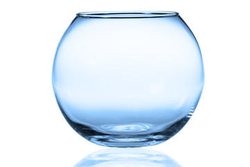 Empty fishbowl without water in front of white background.