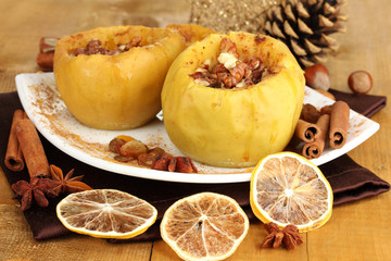 Baked apples on plate on wooden table
