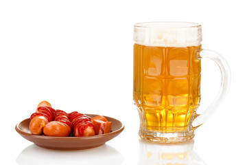Beer and grilled sausages isolated on white