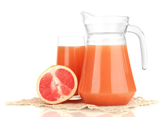 Full glass and jug of grapefruit juice and grapefruits isolated