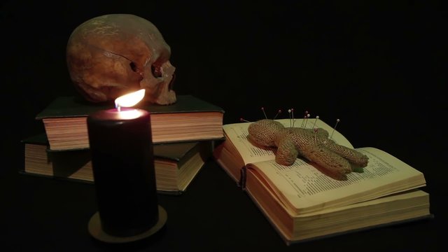 Human skull and voodoo doll
