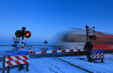 Train and railroad crossing in winter