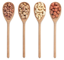 Four wooden spoons with pistachios, cashews and hazelnuts
