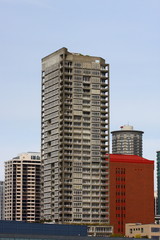 Fototapeta premium Grey Condo Tower by Red Brick