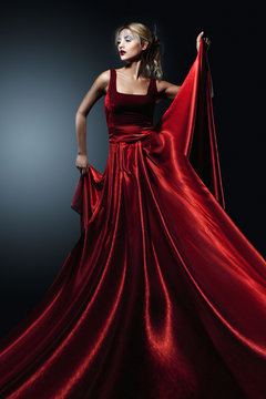 Woman in elegant red dress. Professional makeup and hairstyle