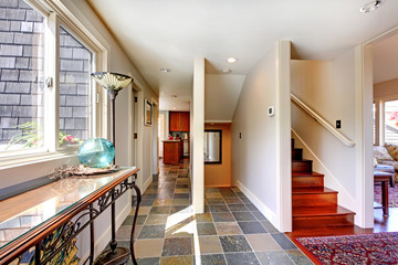 Home large hallway with stairs and window.
