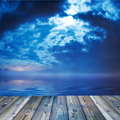 Deck view of a ocean or lake during twilight