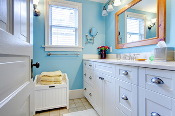 Blue and white bathroom with lots of storage space.