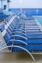 Row of folding lounge chairs on deck