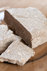 Glass plate with sunflower halva dessert, vertical shot