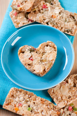 Turquoise saucer with heart-shaped taler cookie, view from above