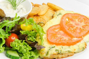 Meat in French with French fries and vegetables
