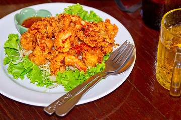 Deep fried squid rings on the plate with salad