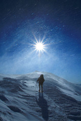 Obraz premium Hiker in winter mountains snowshoeing