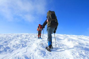 Fototapeta na wymiar Hiker in winter mountains snowshoeing