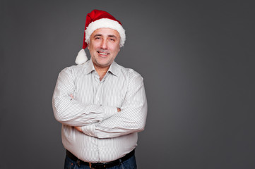 excited senior man in santa claus hat