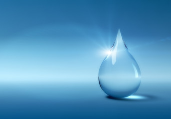 Water drop with copyspace on blue background. Fine noise effect.