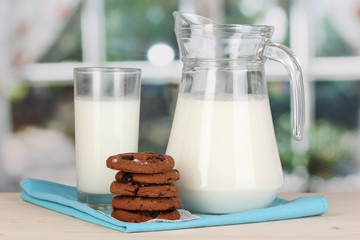 Pitcher and glass of milk with cookies