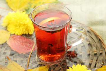 cup of hot drink and autumn leaves, close up