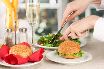 Female hand with  dinner on bright background